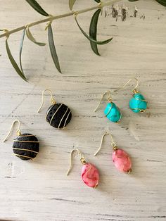 These handmade, wire-wrapped stone earrings are a perfect addition to your nature-inspired jewelry collection. Whether you're dressing up or down, these ornate stones wrapped in delicate wire are sure to make a statement.  *These earrings have hypoallergenic 14k gold-plated earring wires* Length:     - Black stones: 1.5 in/3.81 cm     - Turquoise stones: 1.25 in/3.18 cm     - Pink stones: 1.5 in/3.81 cm Stone Chip Earrings, Unique Wire Dangle Jewelry, Unique Wire Drop Earrings, Gold Natural Stones Earrings Nature-inspired, Gold Nature-inspired Earrings With Natural Stones, Nature-inspired Gold Earrings With Natural Stones, Unique Wire Wrapped Earrings As A Gift, Bohemian Wire Wrapped Wrap Earrings Gift, Wire Jewelry With Matching Earrings For Gift