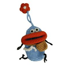 a crocheted stuffed animal with a flower on it's head