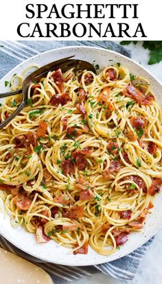 spaghetti carbonara with bacon and parsley in a white bowl