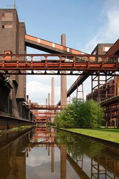 an industrial area with water under a bridge