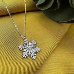 This magnificent necklace combines elegance and elegance. Handmade and carefully designed, this snowflake necklace will make you different on special occasions or in your daily life. It can be a unique gift idea. With its quality silver material and elegant design, this jewelry will make your loved ones very happy. Meaning of Snowflake Silver Necklace: It is to secretly and silently indicate that the person to whom the gift is given will be your one and only. Because every snowflake is unique, different and special. A thin silver necklace combined with a delicate chain will elegantly highlight your neck. - There are silver and gold color options. Features: - 925 sterling silver material -Chain Length: 45 cm - Snowflake: 2 cm - Handmade and special design - Since the product is entirely sil Christmas Silver Cubic Zirconia Necklace, Silver Snowflake Necklace With Cubic Zirconia, Silver Cubic Zirconia Necklaces For Christmas, Elegant Silver Jewelry For Winter, Silver Cubic Zirconia Snowflake Necklace, Silver Snowflake Necklace For Holiday, Elegant Snowflake Shaped Cubic Zirconia Jewelry, Silver Snowflake Necklace Elegant Style, Elegant Silver Snowflake Necklace