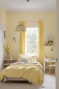 a bedroom with yellow drapes and curtains on the windowsill, bed in foreground