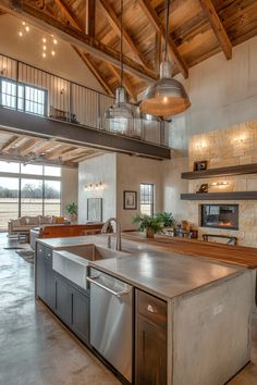 a large kitchen with stainless steel appliances and an island in front of the stove top