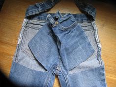 a pair of jeans sitting on top of a wooden floor