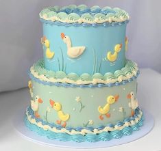 three tiered cake with ducks and flowers on it