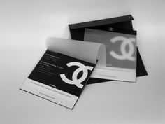 three black and white business cards sitting on top of each other