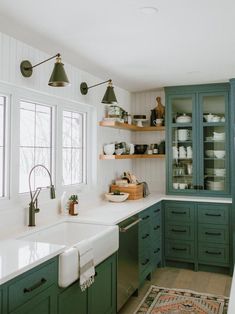 the kitchen is clean and ready for us to use it's green cabinetry