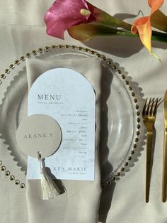 a table setting with place settings and flowers