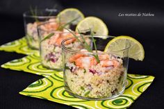 shrimp and rice salad with lemon wedges in glass bowls on yellow place mat next to lime slices