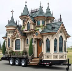 a large truck with an elaborately designed house on the back of it's flatbed