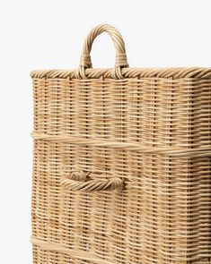 an empty wicker basket with handles on a white background