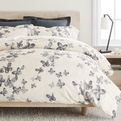 a bed with white and black butterflies on it