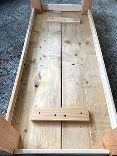 a wooden sleigh sitting on top of a carpeted floor