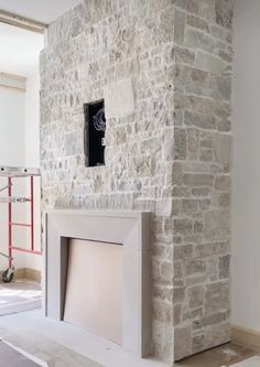 a stone fireplace in the middle of a room