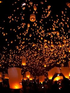 many lanterns are lit up in the night sky