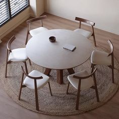 a round table with four chairs around it