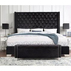 a bed with black leather headboard and foot board