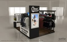 a display case with clothes and t - shirts for sale in an empty store space