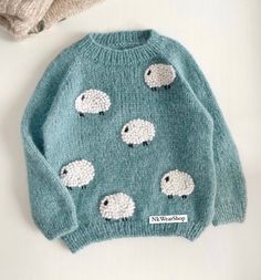 a knitted sweater with sheep on it