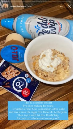 a bowl of oatmeal with yogurt and other items on a wooden table