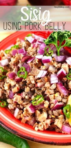 a red plate topped with meat and veggies