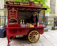 an old fashioned hot dog stand on the sidewalk