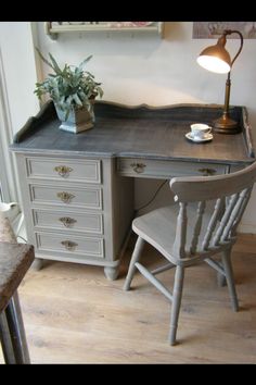 a desk with a chair next to it and a potted plant on the top