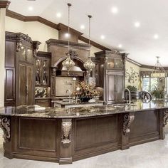 a large kitchen with an island and marble counter tops in the middle of the room