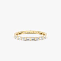 a yellow gold band with baguets and diamonds