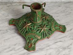 a green vase sitting on top of a marble counter