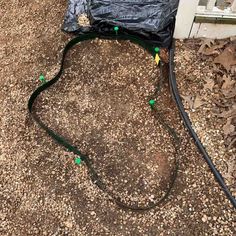 the hose is attached to the back of the house and connected to the power cord