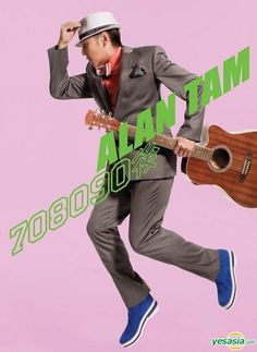 a man in a suit and hat holding a guitar while jumping up into the air