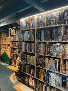 a book store filled with lots of books on shelves next to a green and yellow floor