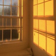 the sun is shining through the window in the room that has no curtains on it