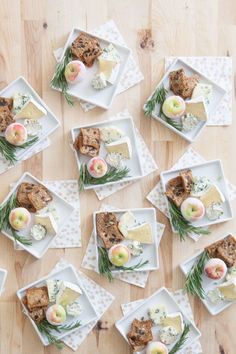 several small plates with food on them sitting on a table next to some napkins