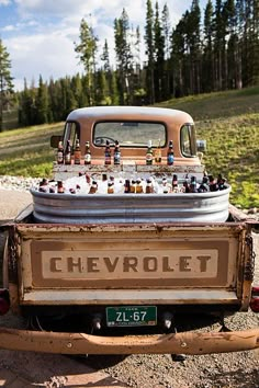 an old chevrolet truck with beer bottles in the back