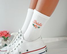 "🧡 Would you like to have peach embroidered flower socks accompany you on your wedding day like a Princess Bride? 👰 Capture the wedding fashion of 2024 with these Custom Embroidery Socks in peach and pink tones! 💨 You can customize the colors on the embroidery to match the most suitable shade for your wedding theme! If you have a different color request, please contact me via message! 📢 You can choose any text up to 7 letters long. For preferences of two words, I can write your text in uppercase and lowercase. 🧦 Socks made of high-quality cotton fabric are compatible in sizes; -       🌟 US: 35-41      🌟 EU: 5-10 📢 PLEASE WRITE THE WORDS YOU WOULD LIKE TO BE WRITTEN FOR EACH PAIR IN THE ORDER NOTE SECTION FOR YOUR TEXTS LONGER THAN 2 WORDS. OTHERWISE, THE ENTIRE TEXT YOU HAVE WRITTE Bridesmaid Socks, Peach Embroidery, Embroidery Socks, Personalised Socks, Wedding Accessories For Bride, Embroidered Socks, Flower Socks, Personalized Socks, Princess Bride