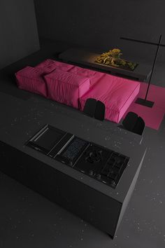 a black counter top with a pink blanket on it