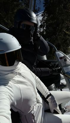 two people riding on the back of a motorcycle