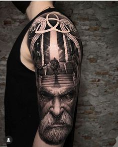 a man's arm with an image of the god and his face on it