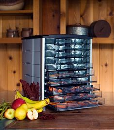 A Weston food dehydrator sits on a countertop next to a sample of the fruits and meats that it can dry Fruit Rollups, Food Dehydrators, Snack Sticks, Food Dehydrator, Small Food, Dried Bananas, Fruit Roll Ups, Meat Snacks, Dried Herbs