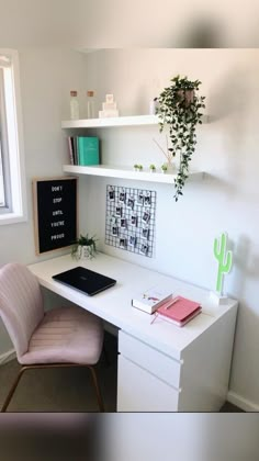 a white desk topped with a laptop computer and a pink chair next to a window