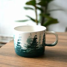 Bring the beauty of the forest into your daily routine with this charming forest-themed mug! Handcrafted with intricate details, this mug is perfect for those who love nature and enjoy their beverages in style. Whether it's coffee, tea, or hot chocolate, this cup will make every sip feel like a walk through the woods. Forest Mug, Artisan Pottery, Pottery Gifts, Handcrafted Ceramics, Unique Ceramics, Ceramic Coffee Cups, Ceramic Cup, Gifts For Nature Lovers, Pottery Painting