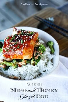 a white bowl filled with rice and broccoli covered in teriyan sauce