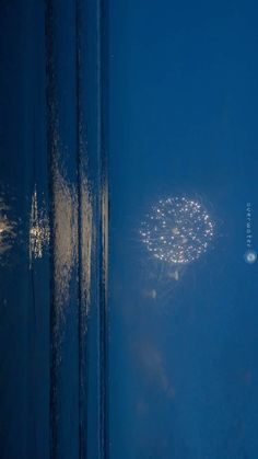 fireworks are lit up in the night sky as seen from an airplane window at night