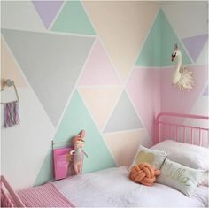 a child's bedroom decorated in pastel colors