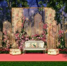 a white bench sitting on top of a pink carpeted floor next to a wall covered in flowers