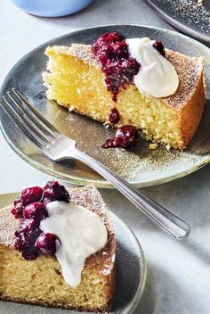 a piece of cake with berries and whipped cream on top is sitting next to a fork