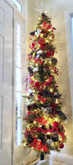 a decorated christmas tree in the corner of a room