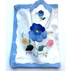 a blue and white bag with flowers painted on it